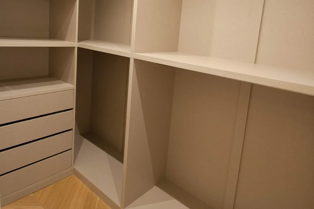 Made-to-measure dressing room with shelves, hanging rails and drawers in a textile finish, on herringbone parquet